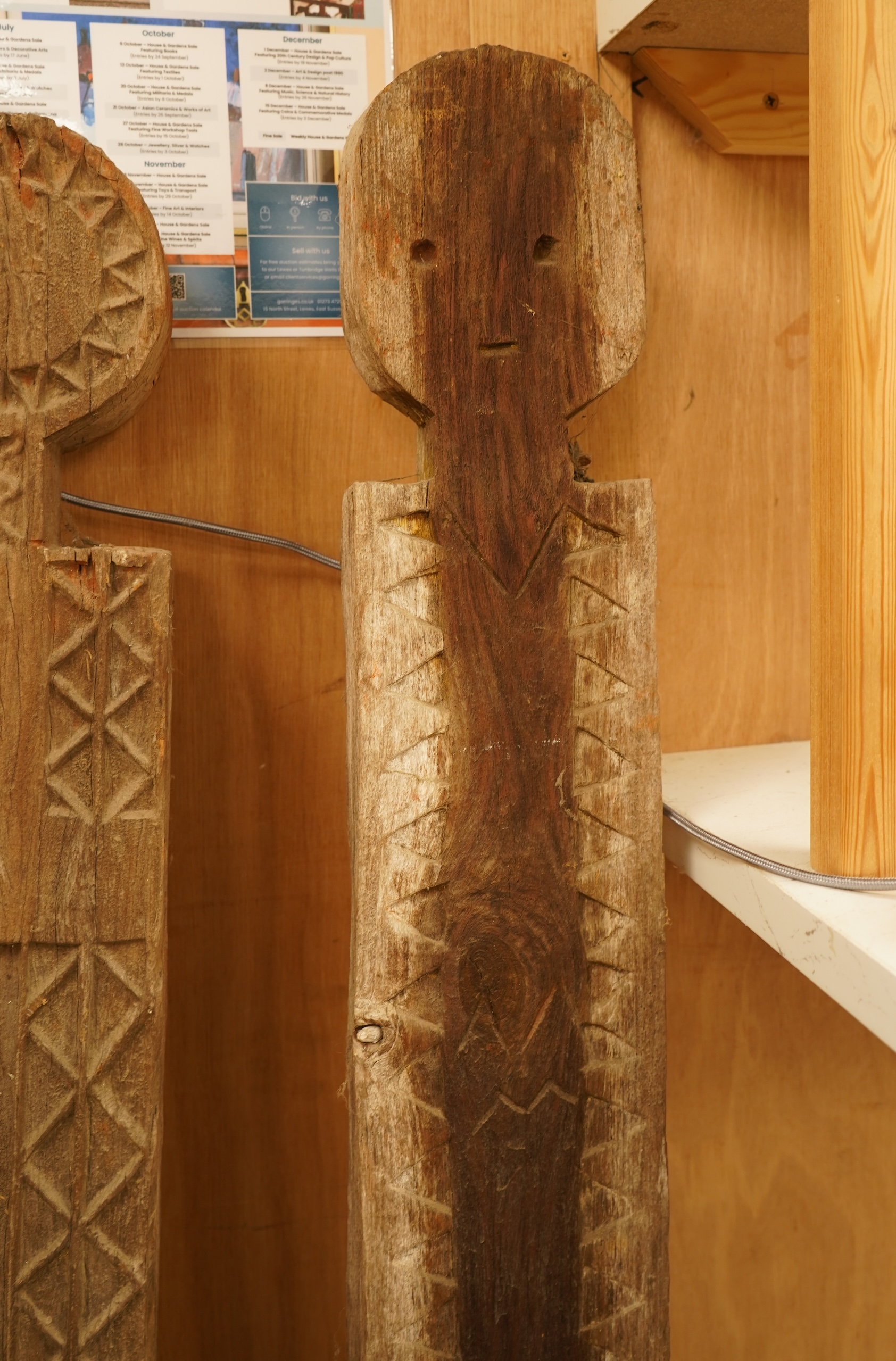 Two African carved wood ancestor figures, tallest 171cm, with two European carved mask capitals